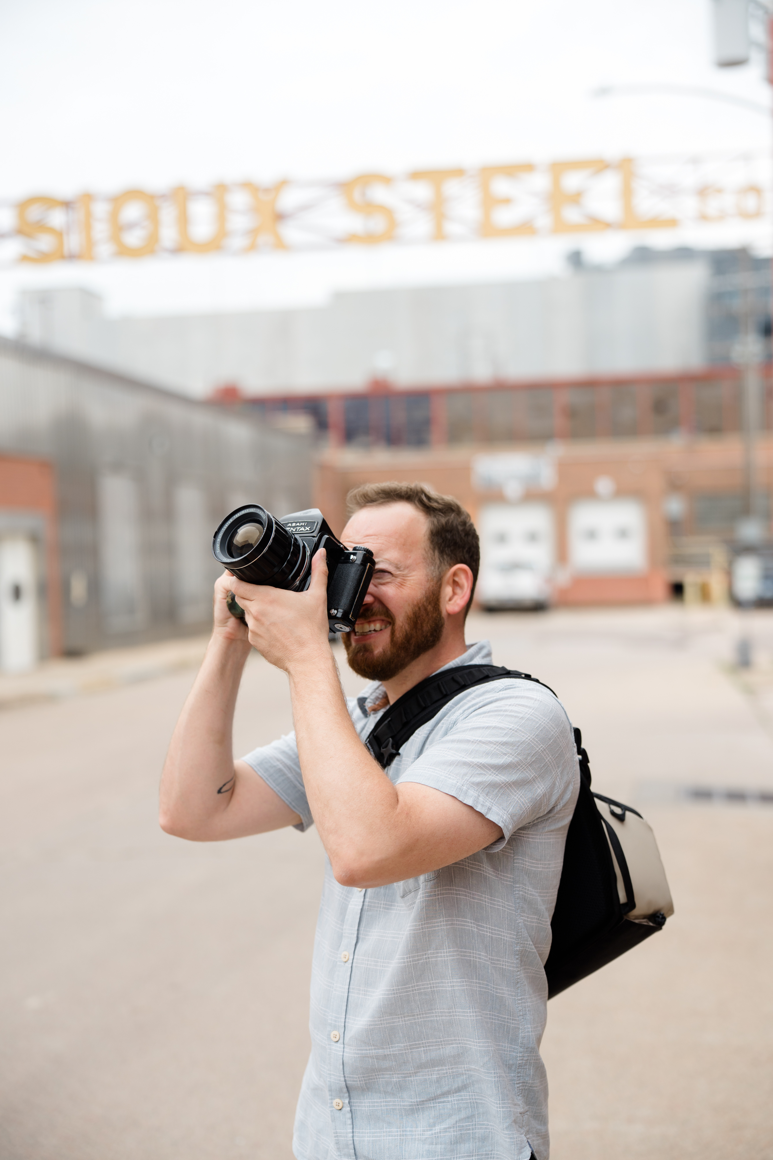 Jeff composing a photograph with a Pentax film camera